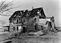 Archival photograph of the ruin of the house taken circa 1935, before it fell down entirely in 1938[6]