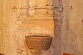 Font for Cagots in the church, with a small sculpture of what is presumed to be a Cagot.