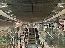 View of the concourse level with the elliptical motif, with an open view of the platform below.