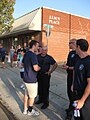 O'Farrell speaks with firefighters along a parade route.