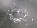 A drop of water hitting a metal surface and crown formation due to splashing of droplet