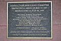 A plaque, located within the grandstand, that commemorates the park's rebuilding after it was destroyed by an arsonist.