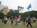 Korean protesters playing drums and raising flags at Victoria Park