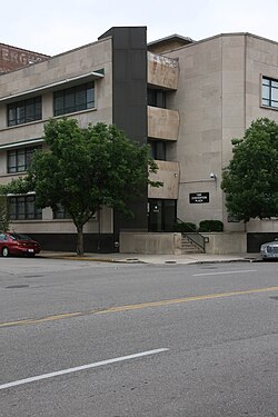 Corner of a three-story limestone building