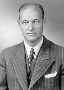 Head and shoulders portrait of a dignified man in his forties, wearing a suit and tie