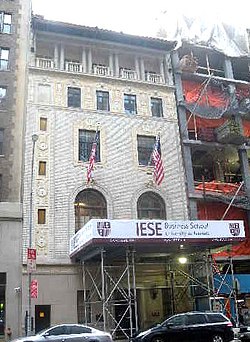 The facade of 165 West 57th Street as seen in 2011. There is scaffolding in front of the building and a banner for IESE Business School on the scaffolding.