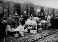 People being deported in cattle wagons cars during World War II