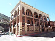 The Copper Queen Library and Bisbee Post Office . The building which both the library and the post office share was the original location of a corner grocery. The post office was established in 1900 and the library in 1907. They are located in 4-6 Main Street.