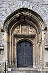 Wooden entrance door with stone arch at St Andrew's Church, Plymouth