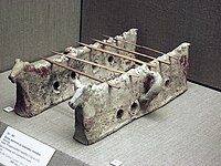 Pair of firedogs with zoomorphic finials and slots for placing skewers, 17th century BC, Akrotiri