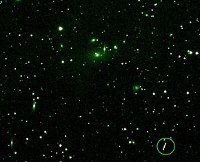 Asteroid Maria passing near a cluster of galaxies