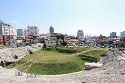 The amphitheatre of the city of Durrës and its port in the background.