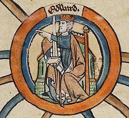 Edward, enthroned and wearing a crown, points with his left hand to the reader's left: his right hand holds a sword. A building, perhaps a church, can be made out behind him.