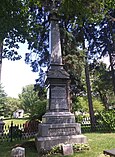 Tall and slender rectangular pillar atop of a rectangular base engraved with names