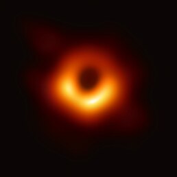 Blackness of space with black marked as centre of donut of orange and red gases