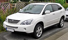 Front quarter view of an SUV parked next to a beach.