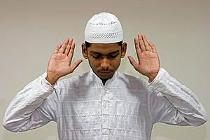 Muslim reciting takbir in prayer