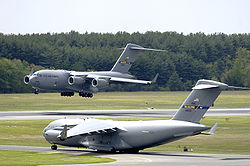 A C-17 Globemaster III from the 305th Air Mobility Wing at McGuire Air Force Base, New Jersey, performs touch and go landings while another C-17 prepares for take-off on Wednesday.