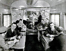 Passengers sitting at tables having a drink