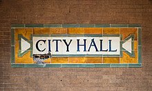 Station name plaque with the word "City Hall" surrounded by faience tiles