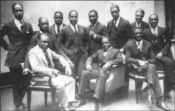 1925 photo taken at the Vox Phonograph Studio — Sam Wooding and his Orchestra; Seated, left to right: Tommy Ladnier (trumpet), John Warren (tuba) (behind), Sam Wooding (piano/leader), Willie Lewis (reeds), George Howe (1892–1936) (drums). Standing, left to right: Herb Flemming (trombone), Eugene Sedric (reeds), Johnny Mitchell (banjo), Bobby Martin (trumpet), Garvin Bushell (reeds), Maceo Elmer Edwards (1900–1988) (trumpet).[28] Not pictured: Arthur Lange (1889–1956), Arthur Johnston (1898–1954), arrangers