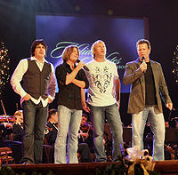 Country music band Lonestar performing at the edge of a stage.