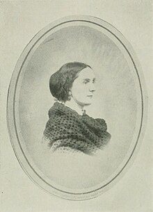 B&W oval portrait photo of a dark-haired woman wearing a dark shawl