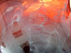 Macro detail from a glass bowl blown at the World of Glass Museum. The white swirl was made by rolling the hot glass in glass powder.