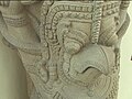 A 12th-century sculpture in the Thap Mam style depicts Garuda the man-bird, serving as an atlas.