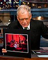 David Letterman holding a matted photograph