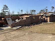 A destroyed brick ranch house