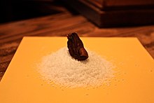A blackened mummified toe on a pile of salt