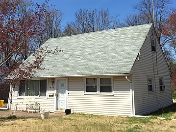 Cape Cod-style house or Cape: a style of a double-pile one-story cottage; low, broad with a steep side-gable roof to which dormers are often added to create a second story (in some locations, referred to as 1.5-story)