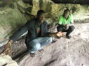 Inside the Tano Rock Shrine with tour guide in Tanoboase, Ghana