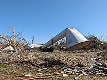 A bent water tower on the ground