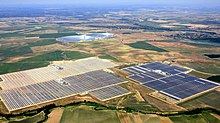 Parts of the Solnova Solar Power Station in the foreground. The two towers of the PS10 and PS20 solar power stations can be seen in the background.