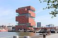 Museum aan de Stroom in Belgium: A large number of curtain wall panels made of natural stone were joined together by means of friction-locked bonding using Akemi adhesives.