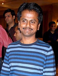 A picture of AR Murugadoss as he looks at the camera.