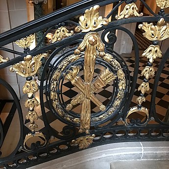 A torch crossed with a sheath with arrows on a railing from the Musée Nissim de Camondo (Paris)