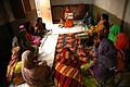 Women sitting on mats on the floor listen to a lecture on pre-natal care, by bri vos