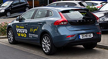 Picture of a blue hatchback car with livery on the doors