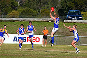 Player taking an overhead mark in a suburban western Sydney AFL]] game between the East Coast Eagles AFC and Campbelltown Kangaroos AFC