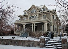 A large home, photographed on a snowy day.