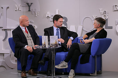 The historians Olaf B. Rader and Arne Karsten talking with Marie Sagenschneider on the blue sofa at the 2013 Frankfurt Book Fair