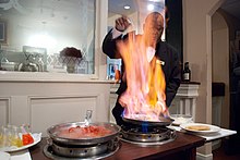 A waiter prepares Bananas Foster at Brennan's