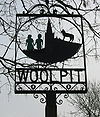 Woolpit village sign depicting the two green children