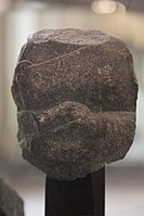 Fragment of the statue of a devotee, with inscription in the name of Naram-Sin: "To the god Erra, for the life of Naram-Sin, the powerful, his companion, the king of the four regions, Shu'astakkal, the scribe, the majordomo, has dedicated his statue".[127]