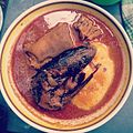 Ghanaian fufu with light soup, goat meat, and smoked fish
