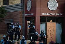 A half-dozen officers guarding police station