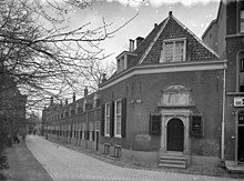 A black and white picture showing a row of houses, taken from the corner of the street